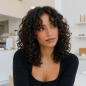 curly-hair-with-curtain-bangs.png